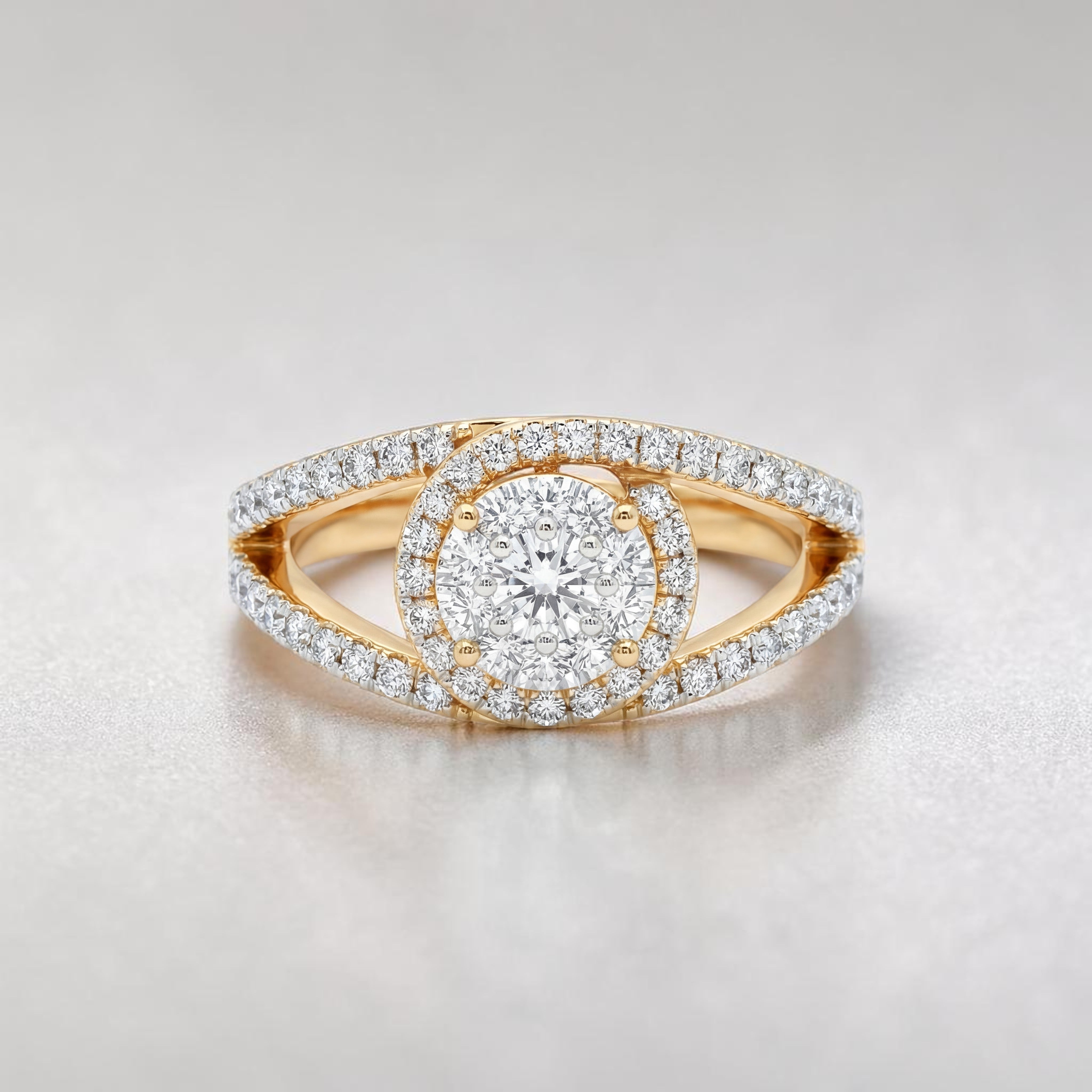 Yellow gold diamond ring featuring a round brilliant center stone encircled by a halo of diamonds, with a split shank band adorned with pavé-set diamonds for added sparkle.