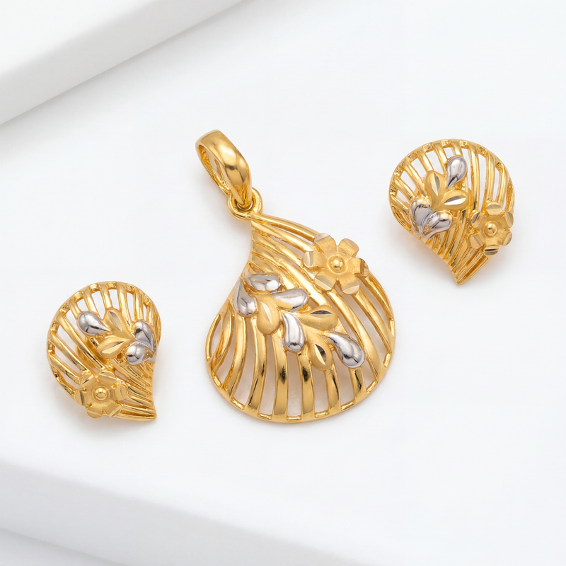Elegant gold jewellery set featuring a fan-shaped pendant and matching earrings with intricate openwork, floral accents, silver-toned highlights, and polished gold detailing.