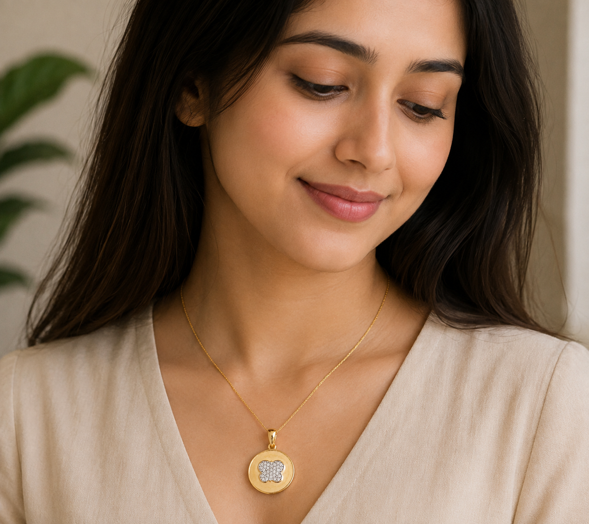 Delicate gold necklace featuring a round pendant with a clustered floral bloom design accented with sparkling stones at the center.