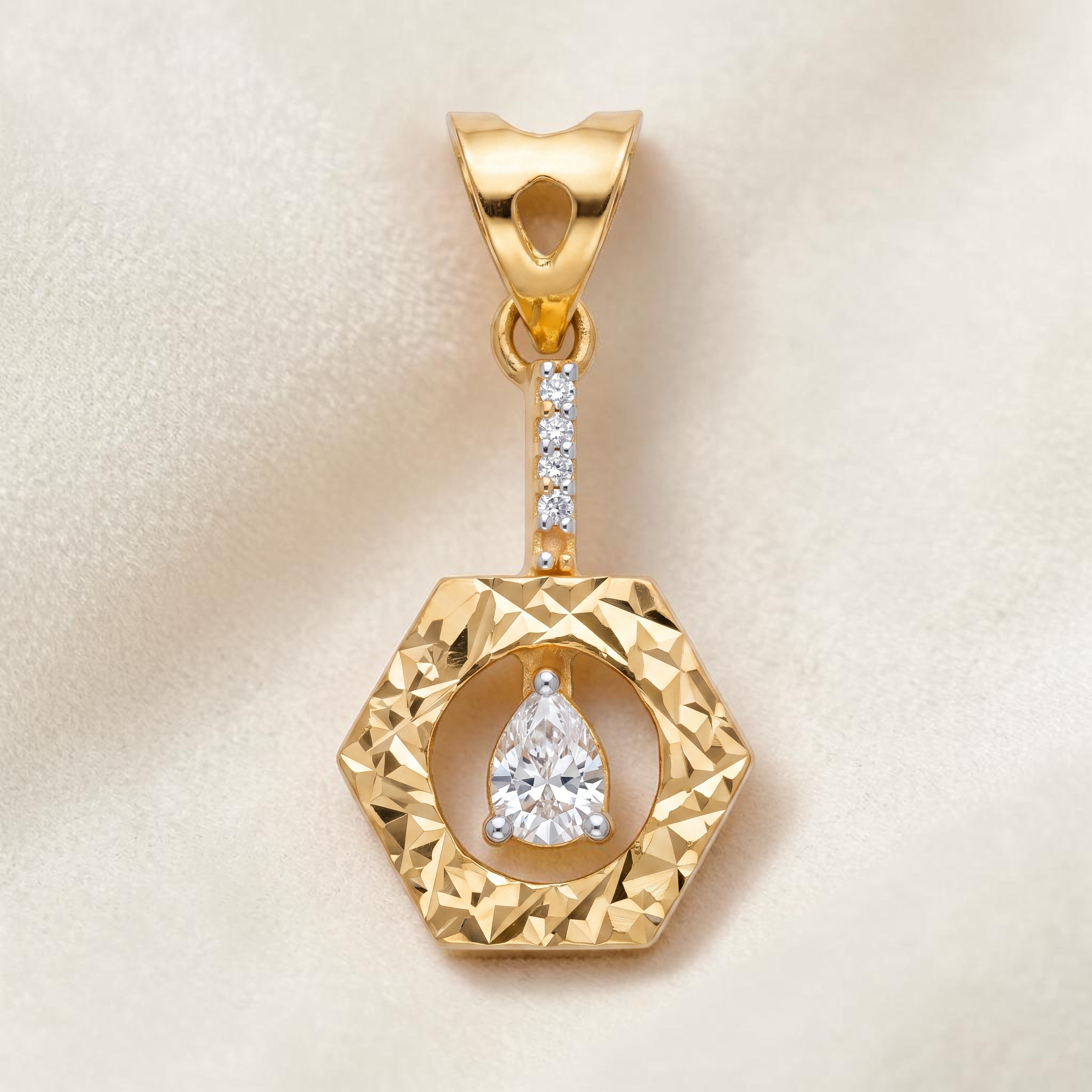 Yellow gold pendant featuring a faceted hexagonal frame with a suspended pear-shaped diamond at the center, accented by a vertical line of small diamonds for a modern and elegant look.