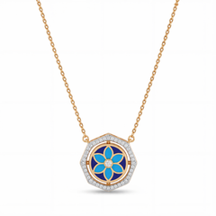 Elegant gold necklace featuring a hexagon-shaped pendant with blue floral enamel detailing and sparkling diamond accents on a white background.
