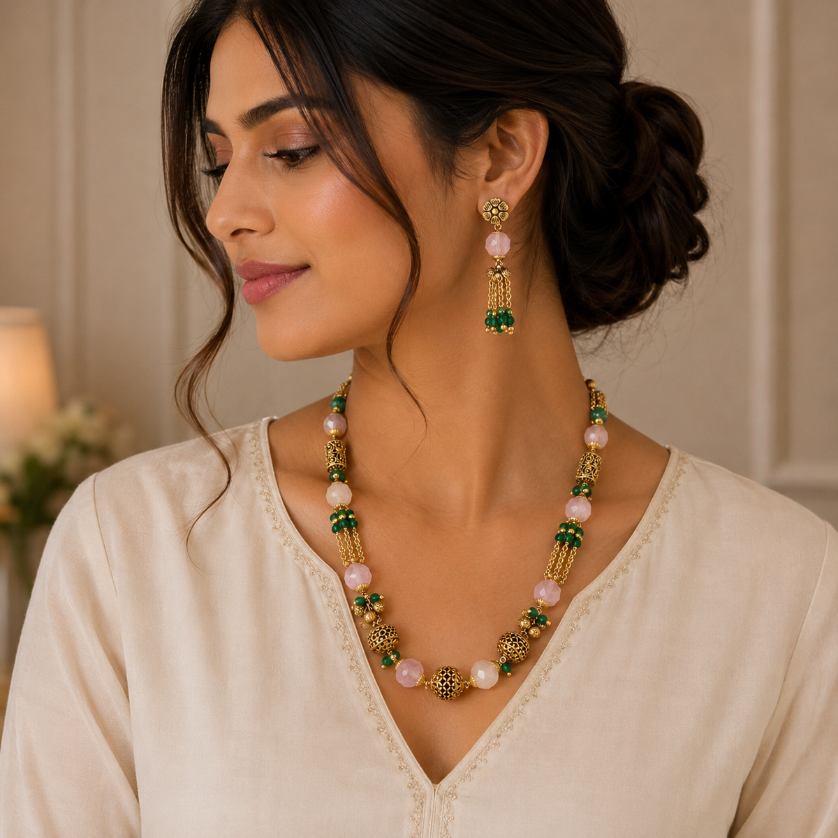 Traditional gold jewellery set featuring pink gemstone beads, green bead accents, ornate gold elements, and matching long drop earrings with delicate bead detailing.