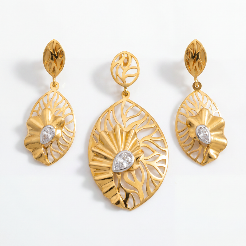 Elegant gold jewellery set featuring a leaf-inspired pendant and matching earrings with intricate openwork patterns, sculpted floral accents, and sparkling diamond details.