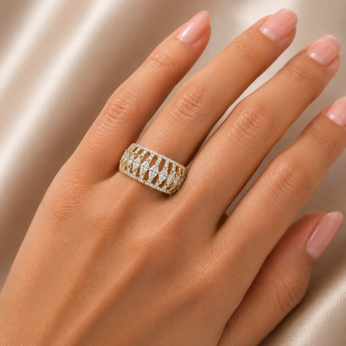 Elegant gold diamond band ring featuring a row of marquise-cut diamonds arranged in a flowing pattern, accented with smaller round diamonds for added sparkle.