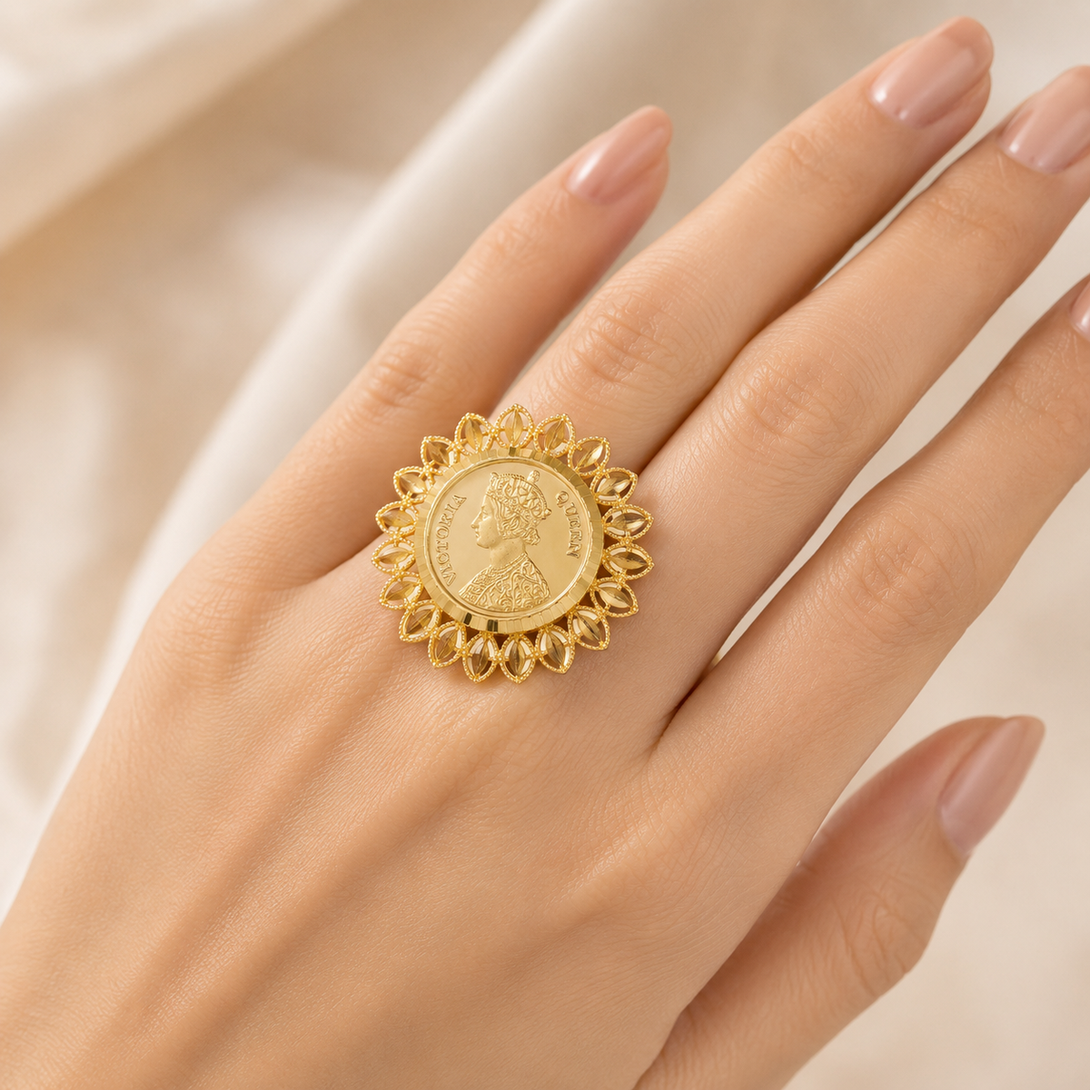 Vintage-inspired gold statement ring featuring a detailed Queen Victoria portrait on a round medallion, surrounded by an ornate floral-inspired border.