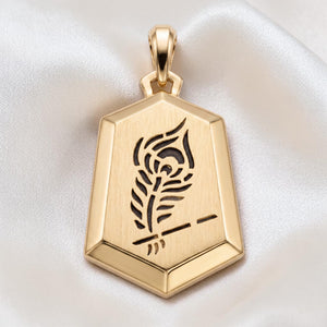 Yellow gold hexagonal pendant featuring a sleek matte finish with an engraved feather motif, offering a modern and minimalist aesthetic.