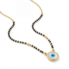 Stylish mangalsutra featuring black bead strands, handcrafted gold chain, protective blue evil eye charm pendant, and contemporary lightweight design for daily wear and gifting.