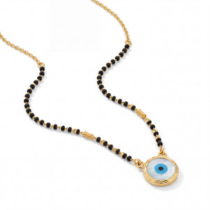 Stylish mangalsutra featuring black bead strands, handcrafted gold chain, protective blue evil eye charm pendant, and contemporary lightweight design for daily wear and gifting.
