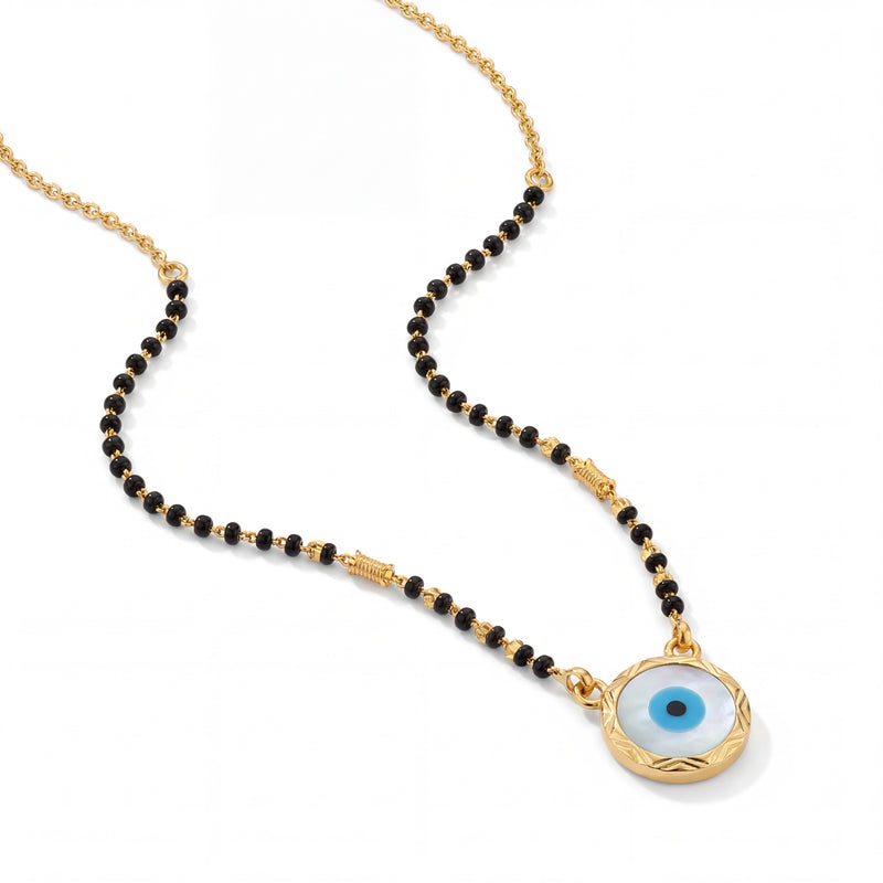 Stylish mangalsutra featuring black bead strands, handcrafted gold chain, protective blue evil eye charm pendant, and contemporary lightweight design for daily wear and gifting.