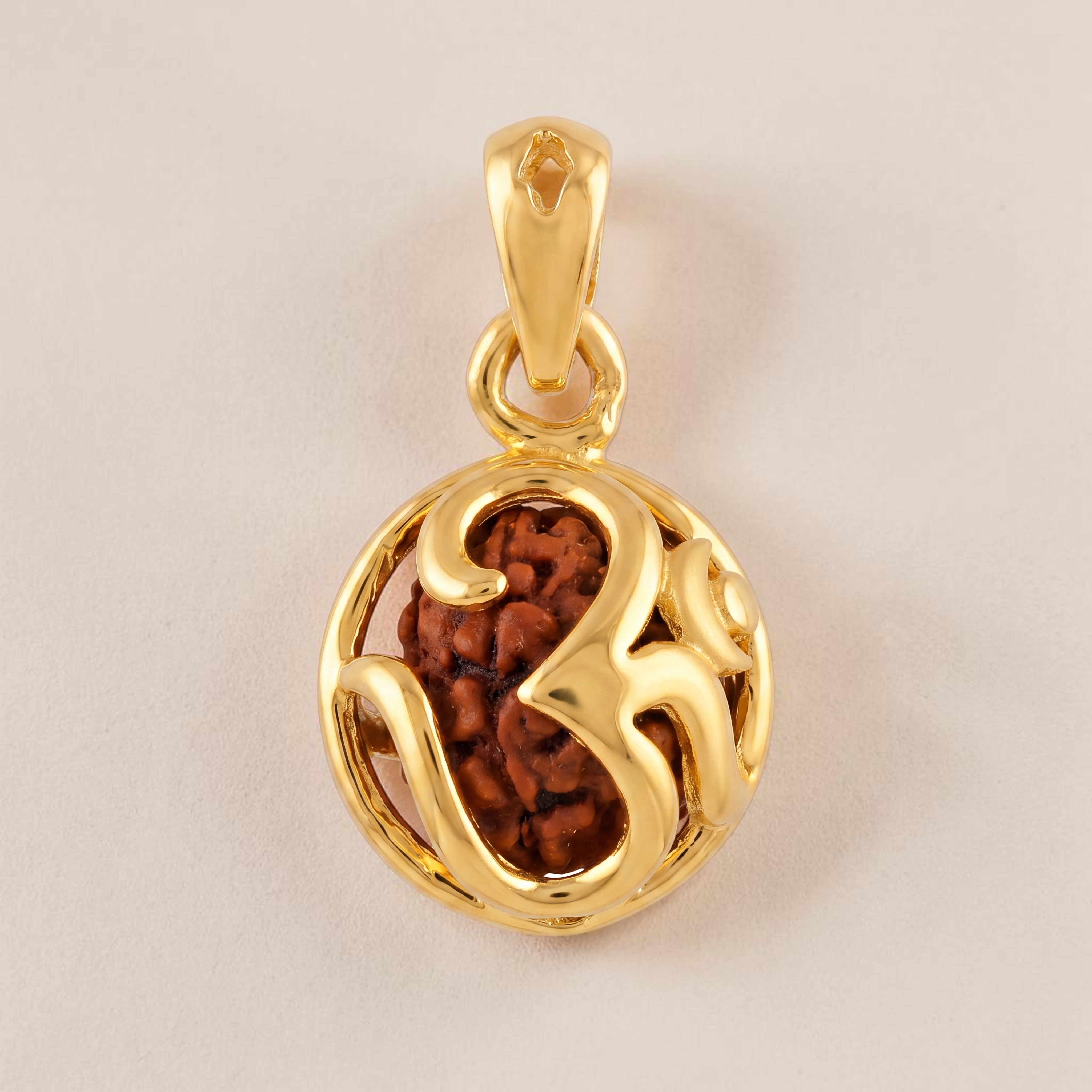 Yellow gold pendant featuring a natural Rudraksha bead encased within an openwork Om symbol design, symbolizing divine energy, protection, and spiritual harmony.