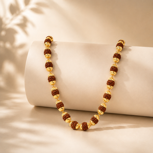 Elegant gold necklace featuring textured Rudraksha beads paired with ornate gold bead caps and decorative accents, creating a luxurious traditional long-chain jewellery design.
