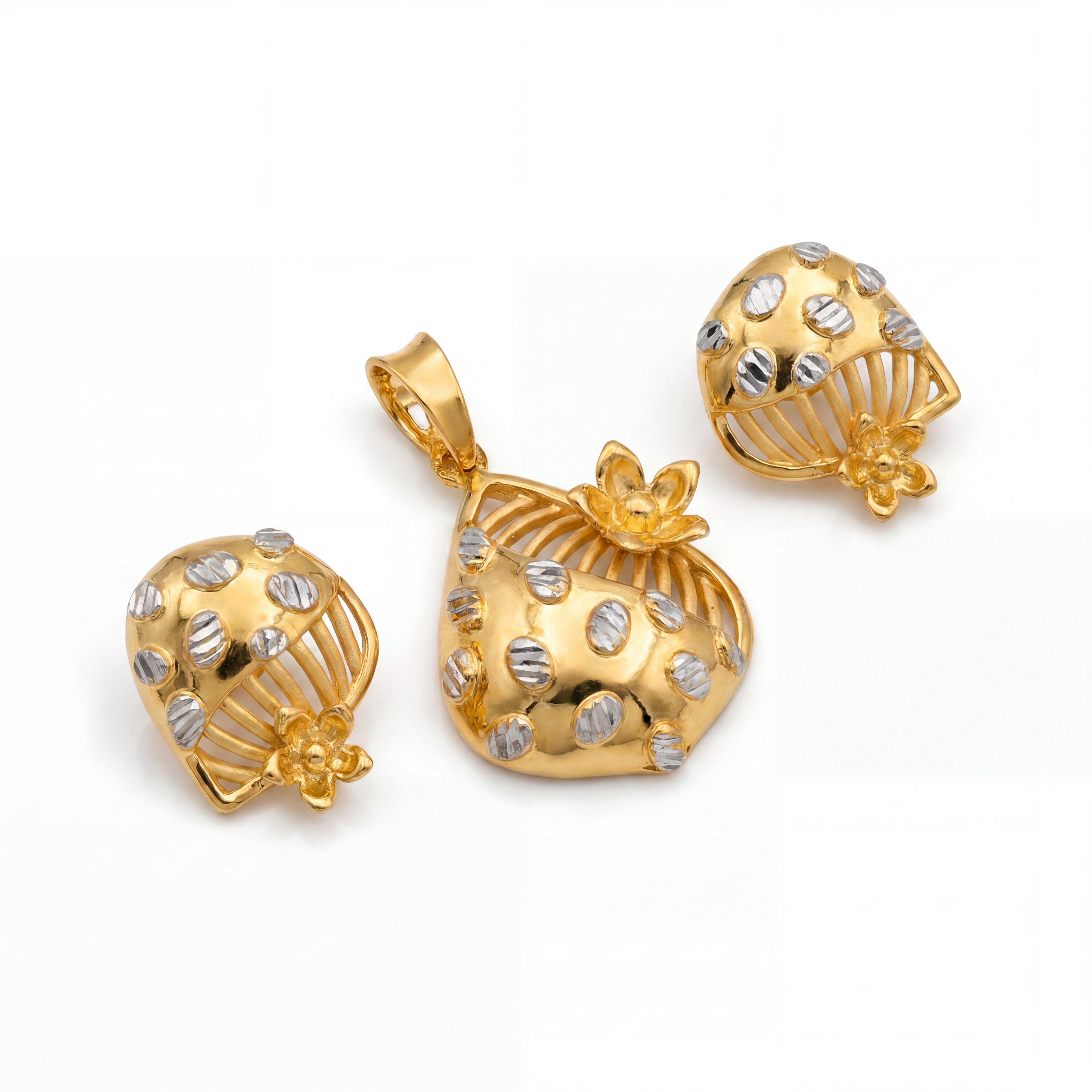 Elegant gold jewellery set featuring a rounded dome-shaped pendant and matching earrings, accented with silver-toned textured details, openwork arches, and delicate floral motifs.