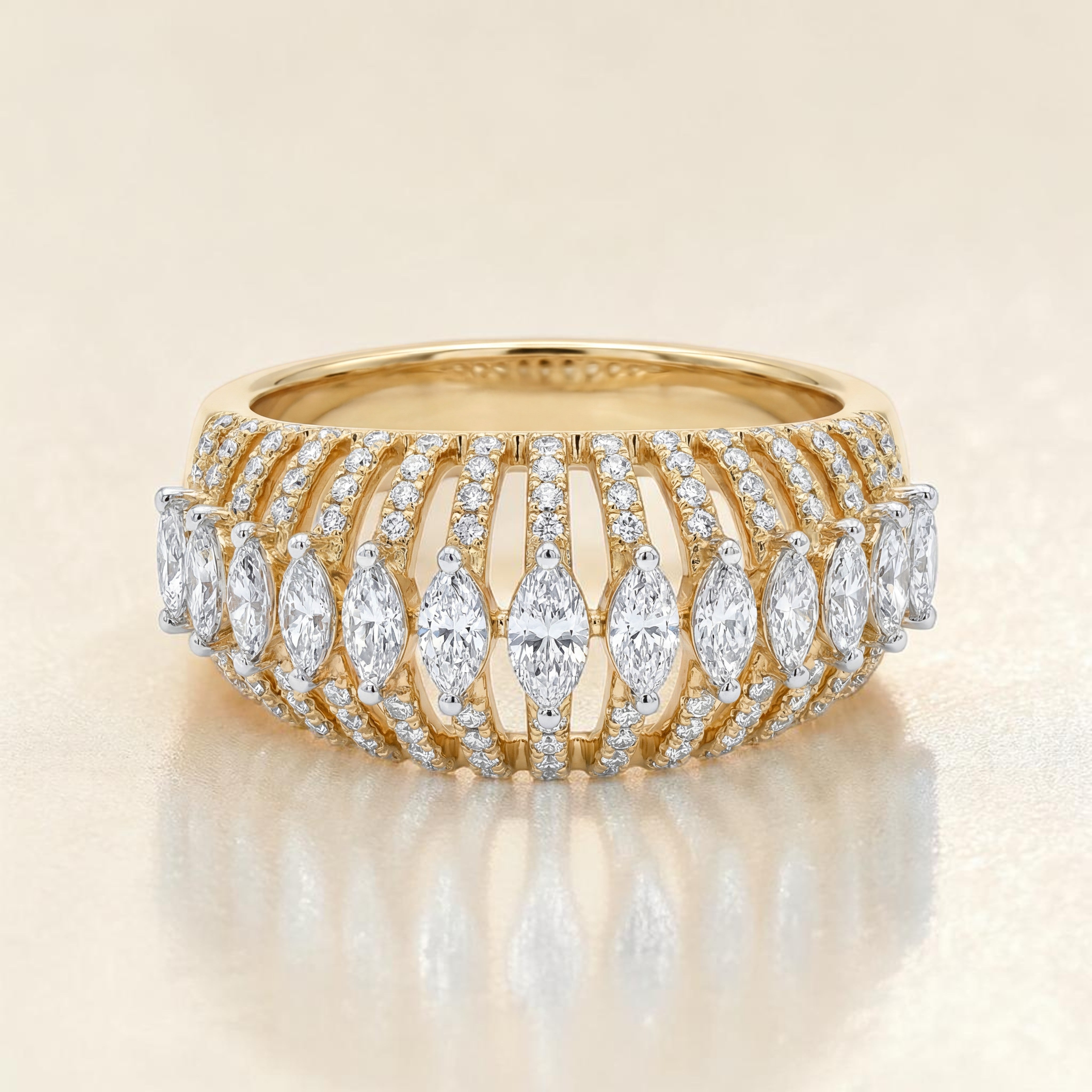 Yellow gold wide band ring featuring multiple rows of pavé-set diamonds with a central line of marquise-cut diamonds, creating a layered and luxurious statement design.