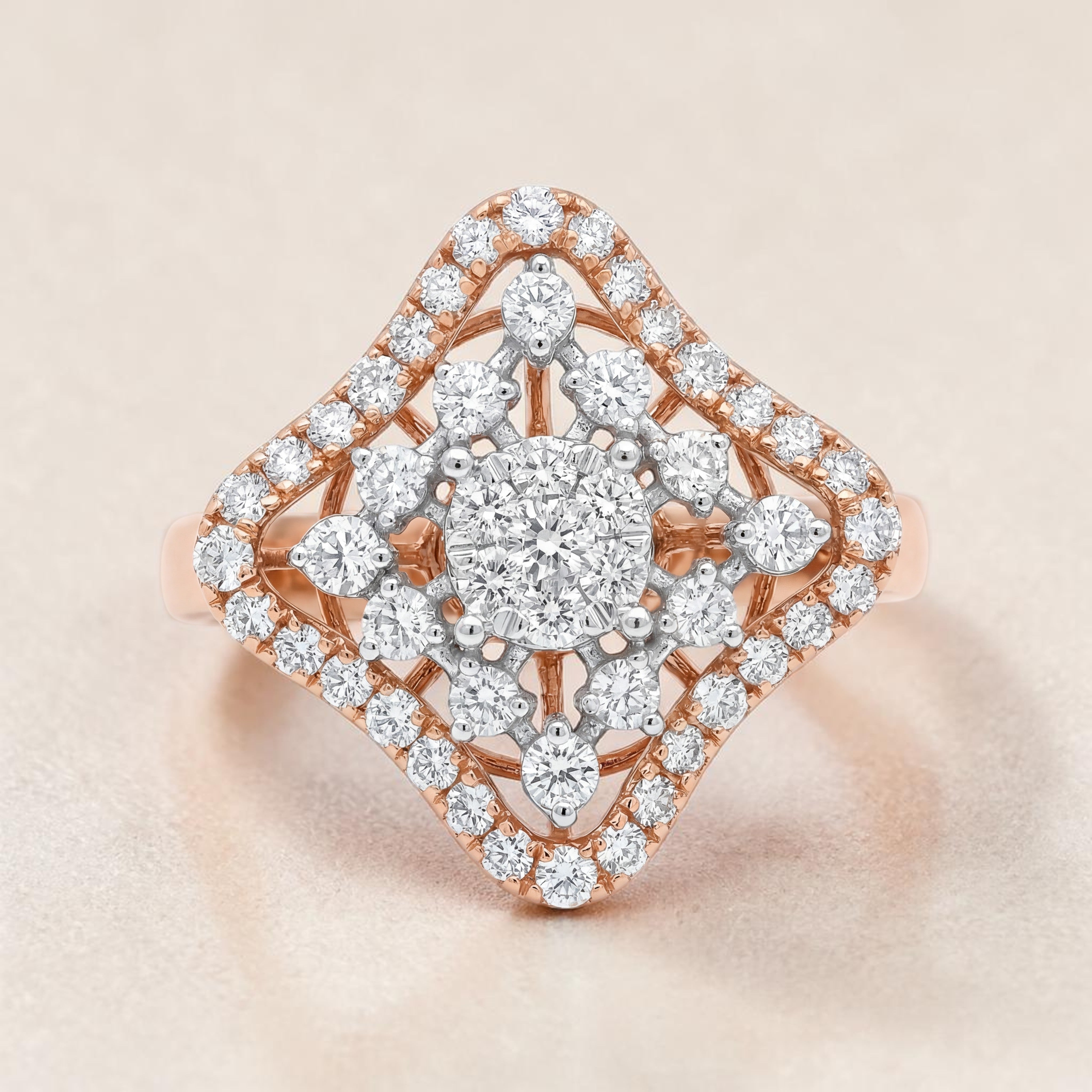 Rose gold diamond ring featuring a round brilliant center stone, surrounded by a star-shaped cluster of diamonds and a double halo with intricate openwork detailing for a radiant, geometric look.