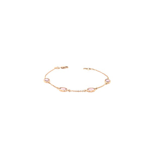 Elegant rose gold bracelet featuring oval pink gemstones spaced along a delicate chain with an adjustable clasp on a white background.