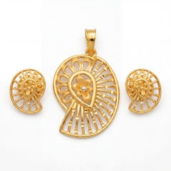 Elegant gold jewellery set featuring a paisley-inspired pendant and matching earrings with a central floral motif, intricate radial openwork, and polished gold detailing.