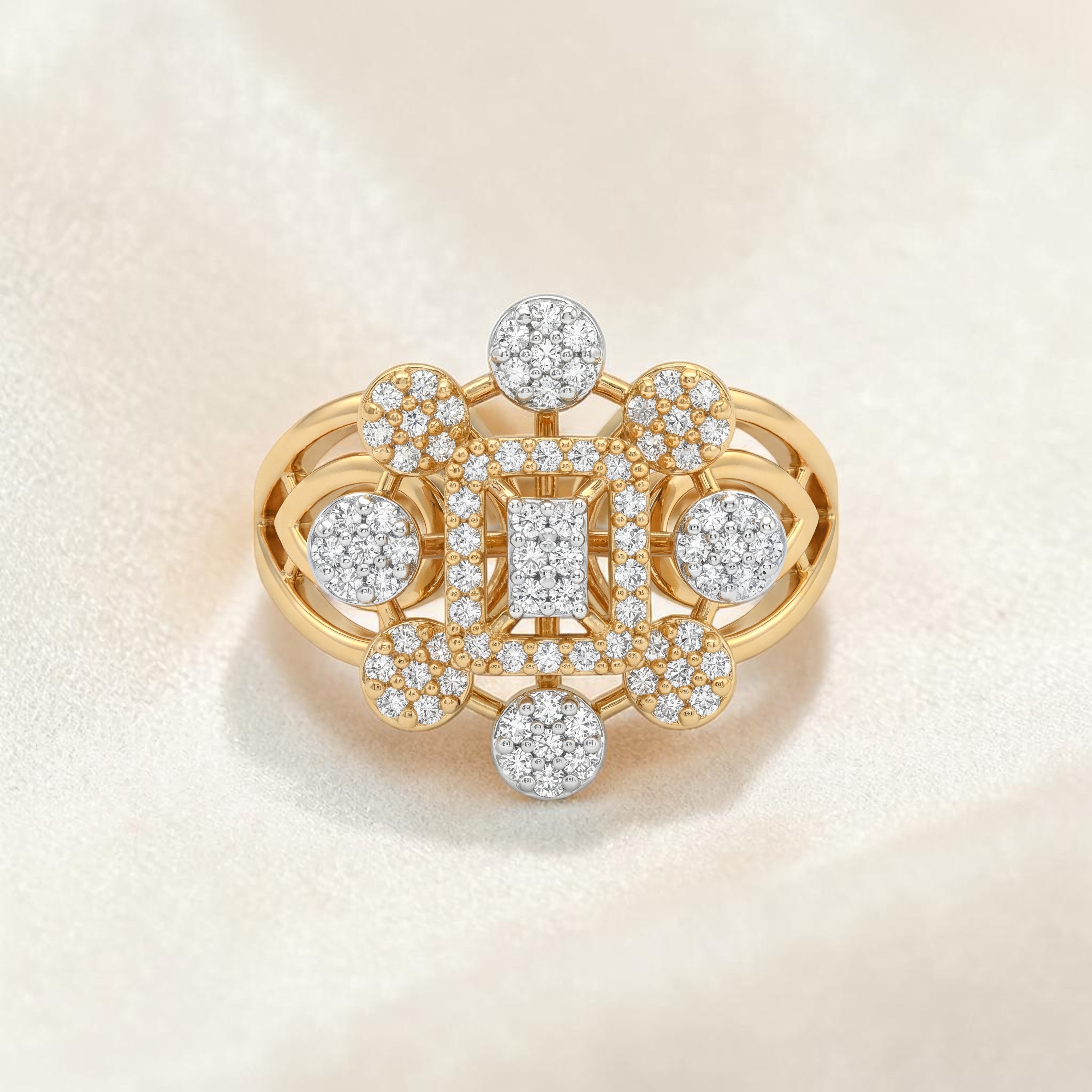 Yellow gold ring featuring a rectangular diamond cluster center surrounded by circular diamond motifs and intricate openwork detailing, creating a bold geometric statement design.