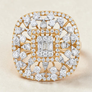 Luxurious square-shaped diamond cocktail ring in yellow gold featuring a baguette diamond cluster center, surrounded by a double halo and intricate openwork design with pear-shaped and round diamonds radiating outward.