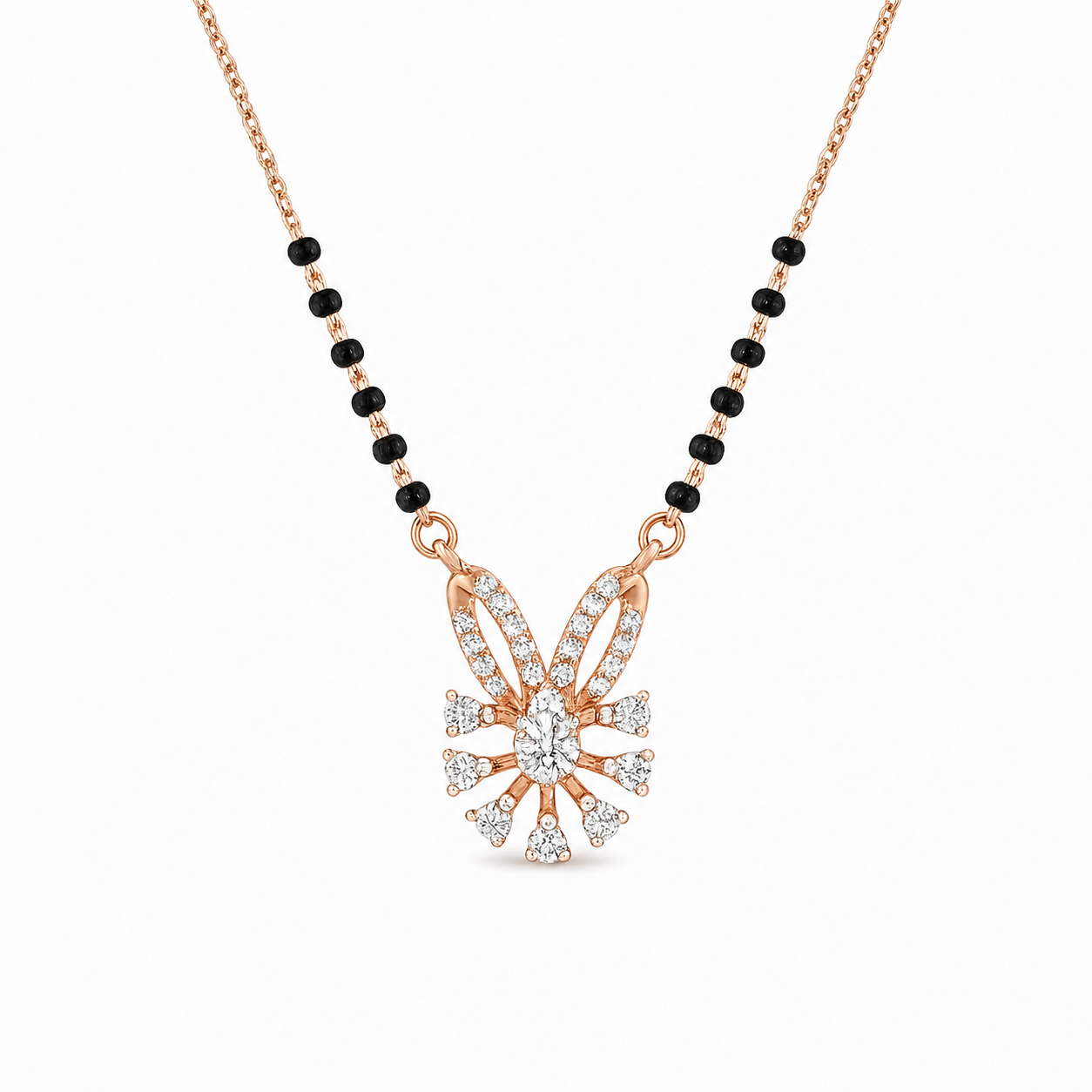 Elegant rose gold mangalsutra necklace featuring black beads and a sparkling floral-inspired diamond drop pendant with intricate detailing on a white background.