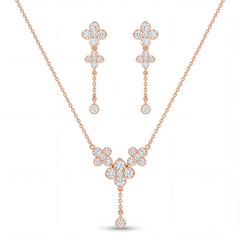 Elegant rose gold diamond jewelry set featuring a floral drop pendant necklace with matching dangling floral earrings on a white background.