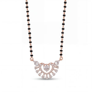 Elegant rose gold mangalsutra necklace featuring black beads and a sparkling heart-shaped floral diamond pendant with intricate detailing on a white background.