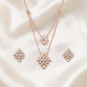 Elegant rose gold diamond jewelry set featuring a layered floral pendant necklace and matching floral stud earrings on a white background.