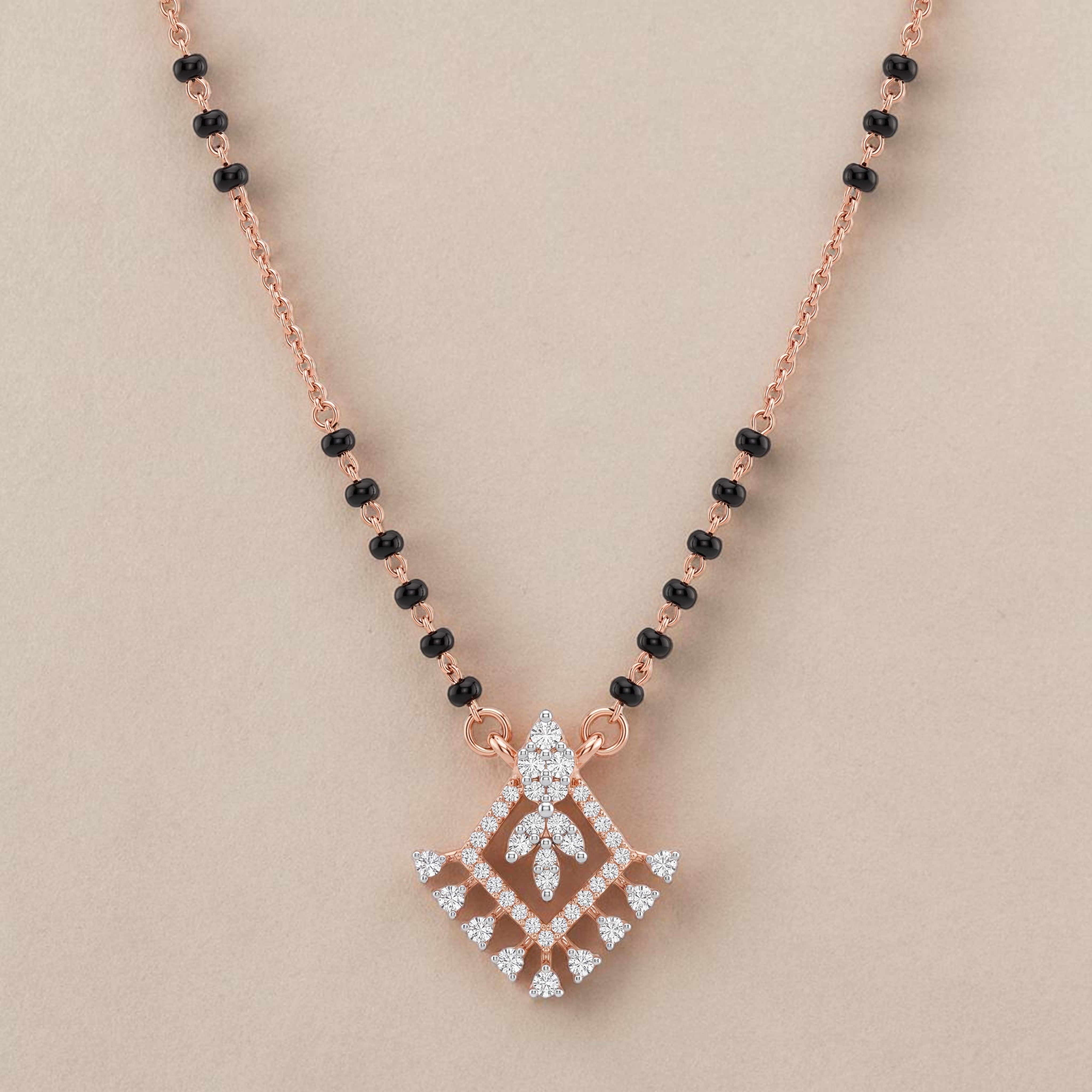 Elegant rose gold mangalsutra necklace featuring black beads and a royal-inspired diamond drop pendant with intricate sparkling detailing on a white background.