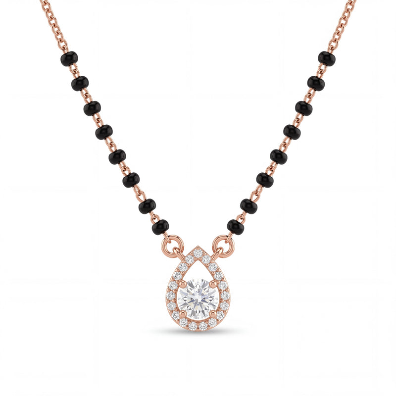 Elegant rose gold mangalsutra necklace featuring black beads and a sparkling teardrop-shaped diamond pendant with halo detailing on a white background.