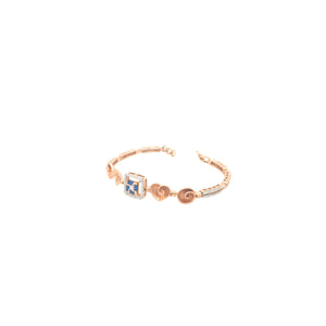 Elegant rose gold bracelet featuring heart motifs, a square blue sapphire centerpiece, and sparkling diamond accents with an adjustable clasp on a white background.