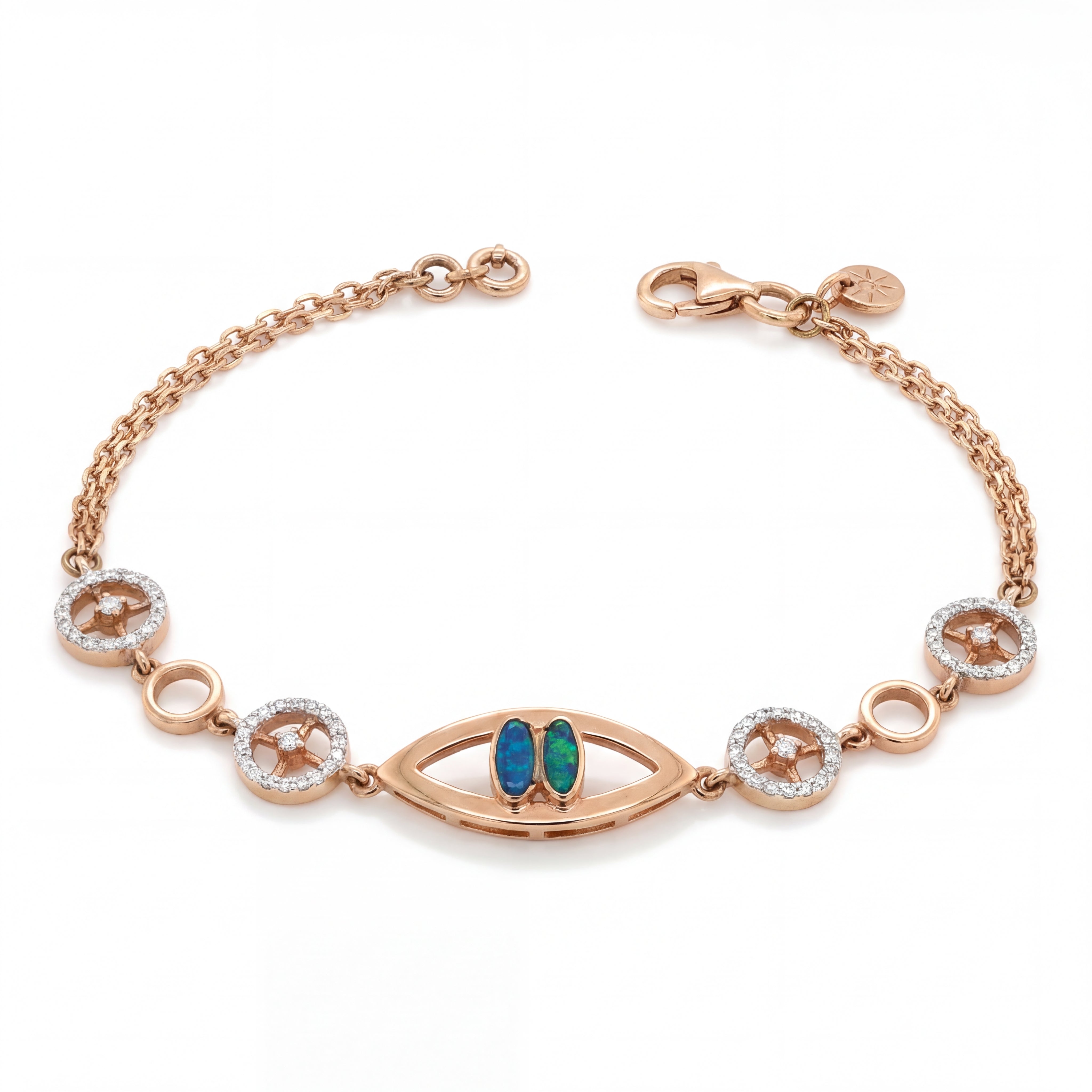 Stylish rose gold bracelet featuring an evil eye centerpiece with blue opal accents and sparkling circular diamond motifs on a delicate chain with adjustable clasp.