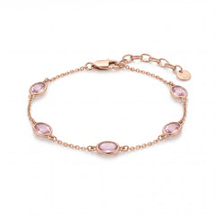 Elegant rose gold bracelet featuring oval pink gemstones spaced along a delicate chain with an adjustable clasp on a white background.