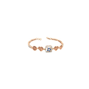 Elegant rose gold bracelet featuring heart motifs, a square blue sapphire centerpiece, and sparkling diamond accents with an adjustable clasp on a white background.