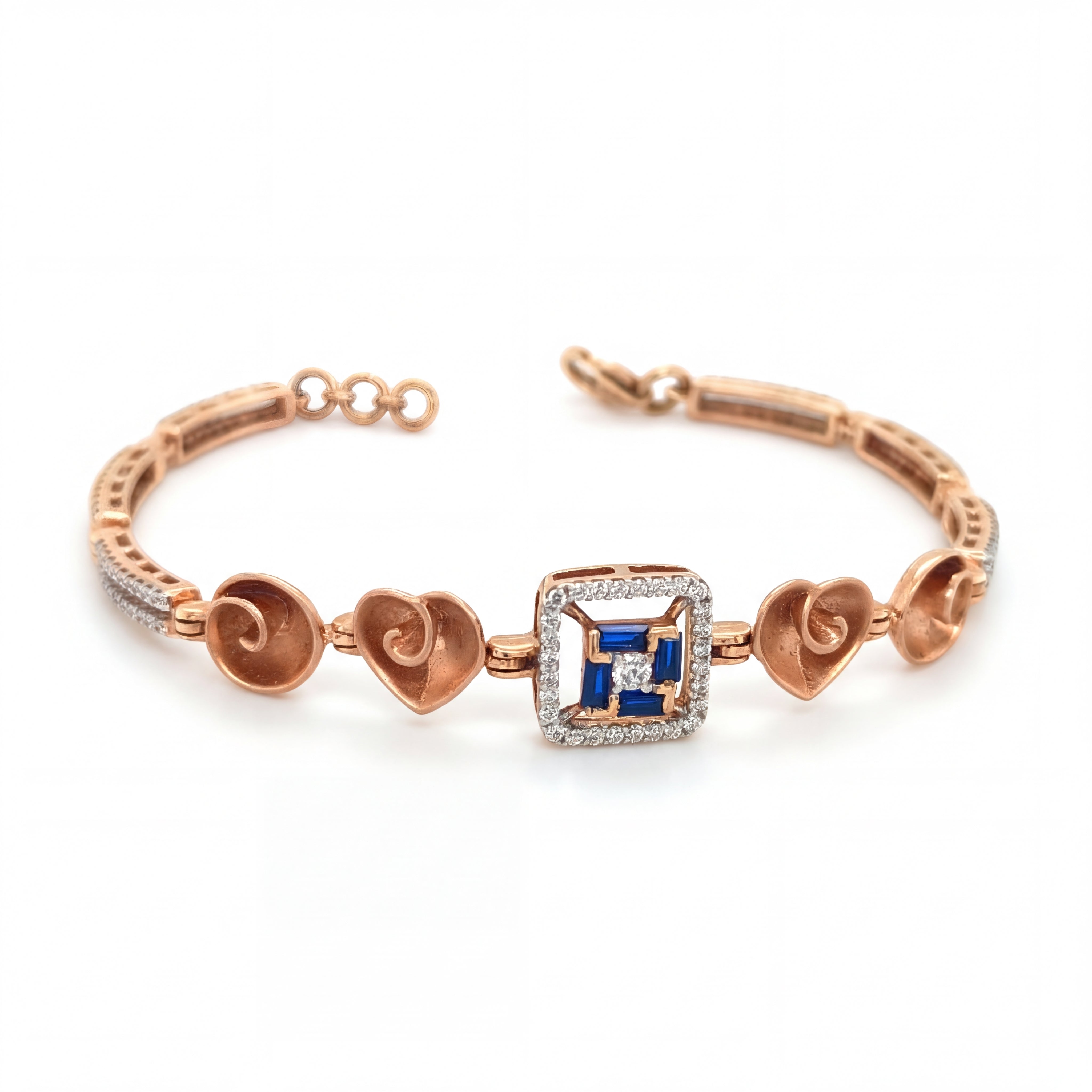 Elegant rose gold bracelet featuring heart motifs, a square blue sapphire centerpiece, and sparkling diamond accents with an adjustable clasp on a white background.