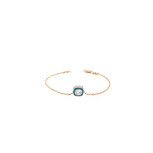 Elegant rose gold bracelet featuring a solitaire crystal centerpiece with turquoise enamel detailing on a delicate chain and adjustable clasp against a white background.