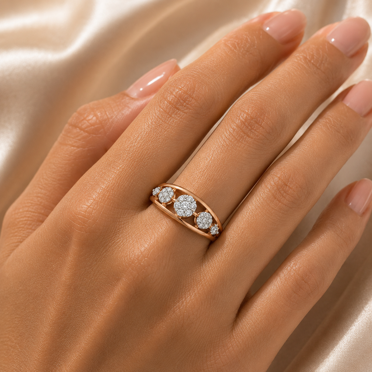 Elegant rose gold ring featuring three round diamond clusters arranged across a smooth curved band, accented with smaller diamonds for a delicate and sophisticated finish.