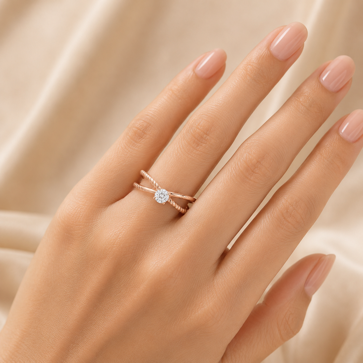 Delicate rose gold ring featuring a round brilliant diamond at the center, framed by two gracefully twisted bands for an elegant and contemporary finish.