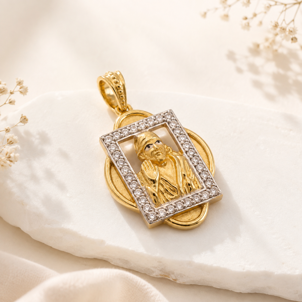 Gold Sai Baba pendant featuring an intricate seated figure framed by a rectangular border of sparkling diamonds, with detailed goldwork and a decorative bail.