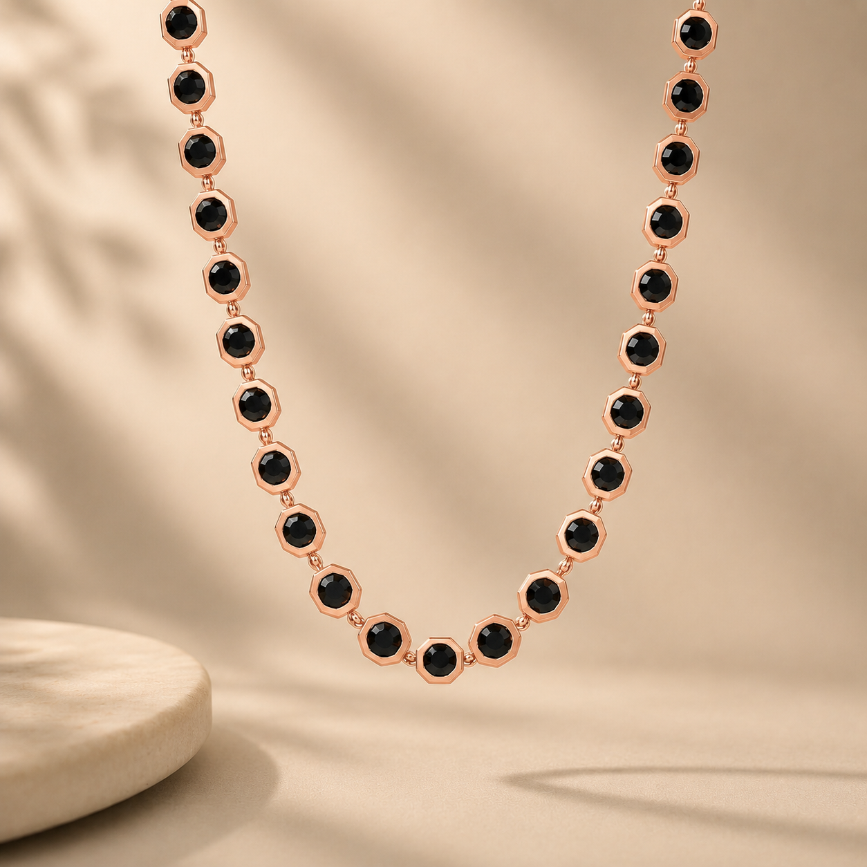 Elegant rose gold necklace featuring evenly spaced faceted black gemstones set in geometric frames, connected by delicate links for a modern and sophisticated look.