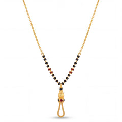 Elegant 22K gold mangalsutra necklace with black bead chain, ruby accent side details, and ornate tassel pendant with red stones on a white background by Pachchigar Jewellers Ashokbhai.