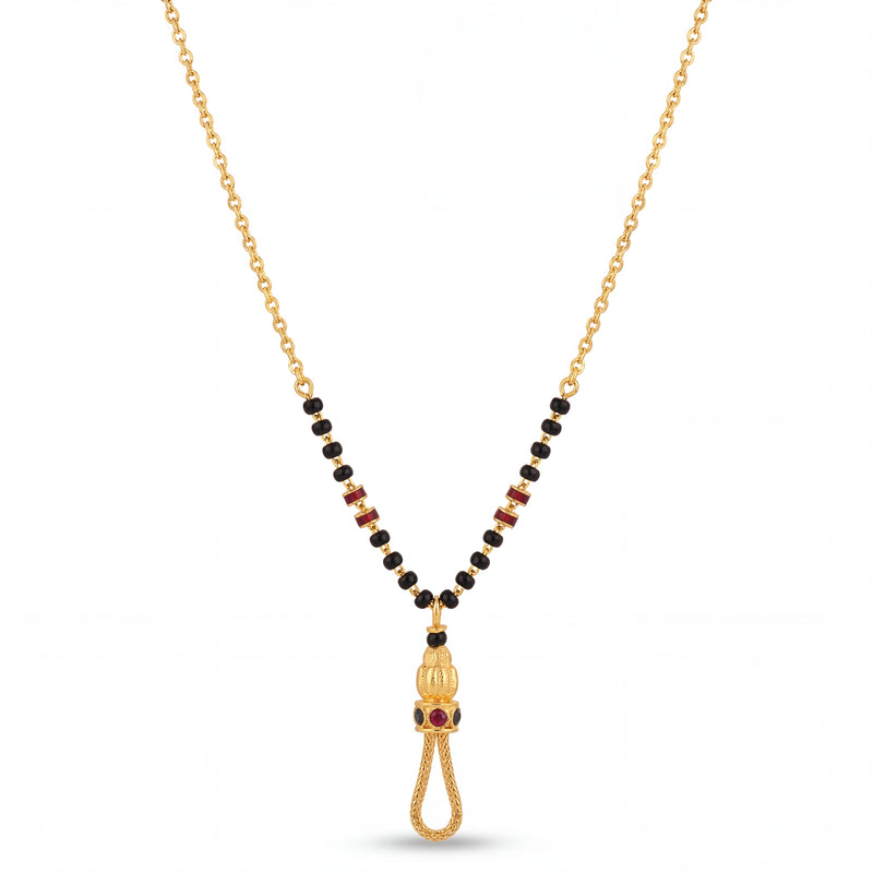 Elegant 22K gold mangalsutra necklace with black bead chain, ruby accent side details, and ornate tassel pendant with red stones on a white background by Pachchigar Jewellers Ashokbhai.