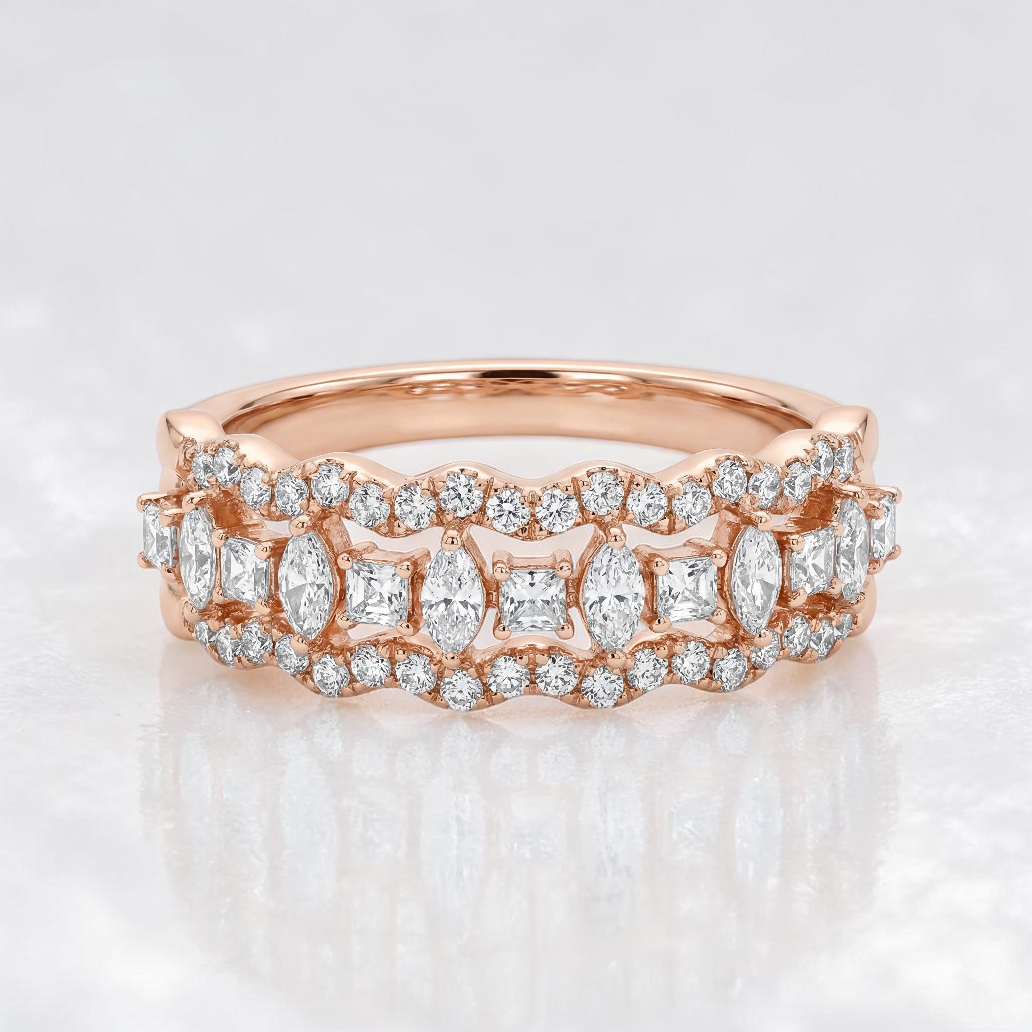Rose gold eternity-style band featuring alternating marquise and princess-cut diamonds framed by delicate pavé diamonds, creating a vintage-inspired continuous sparkle design.